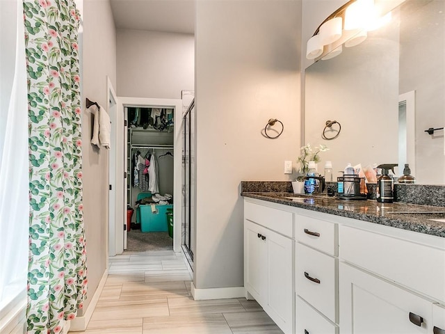 1301 Atalon Dr, Moore, OK 73160 - bathroom with double vanity, a stall shower, and a walk in closet