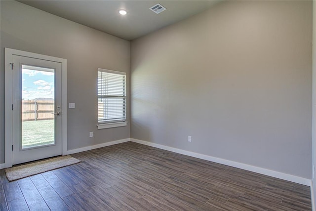 entryway with dark hardwood / wood-style flooring and a healthy amount of sunlight