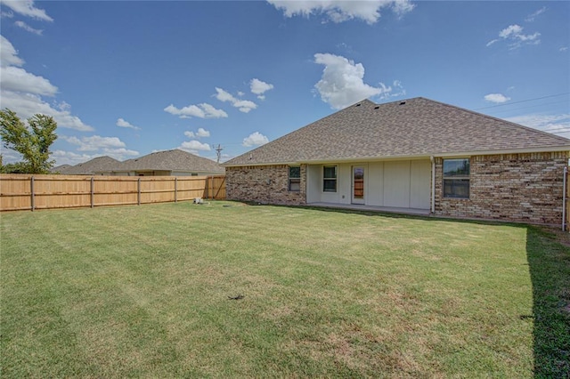 rear view of property with a lawn