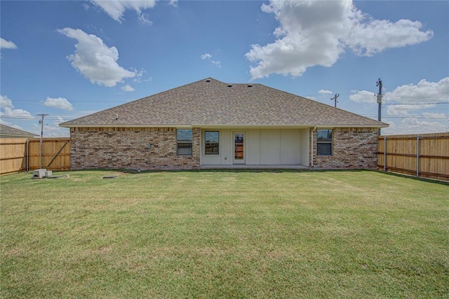 rear view of house featuring a lawn