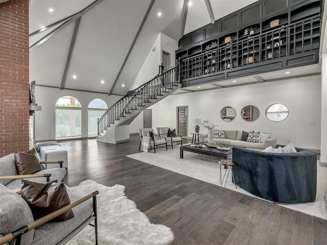 living room featuring beamed ceiling, wood-type flooring, and high vaulted ceiling