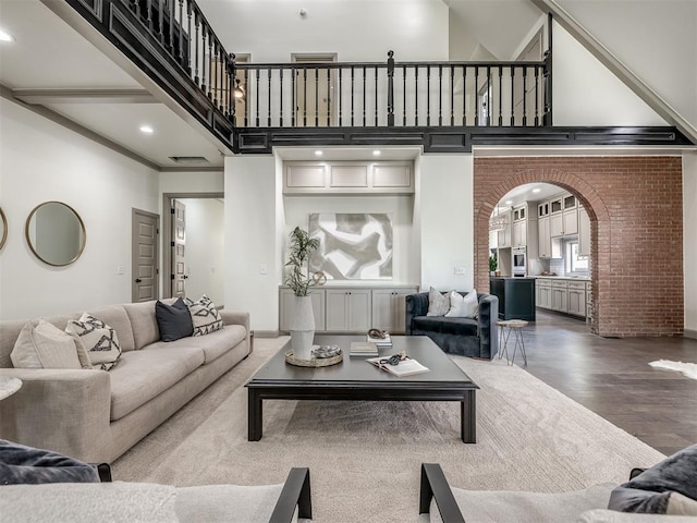 living room featuring a high ceiling and hardwood / wood-style flooring