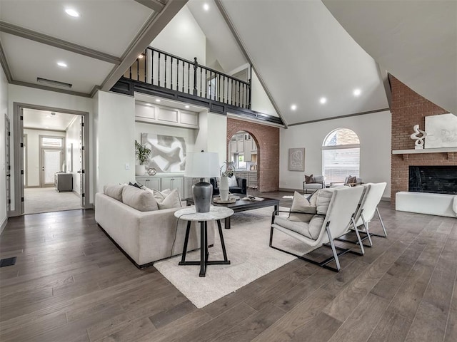 living room featuring a fireplace, dark hardwood / wood-style flooring, and ornamental molding