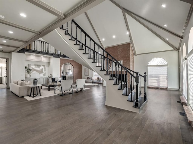 interior space featuring beamed ceiling, hardwood / wood-style flooring, and high vaulted ceiling