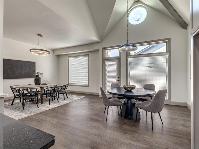 dining space featuring dark hardwood / wood-style flooring and vaulted ceiling