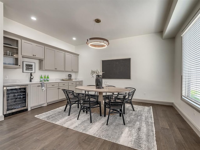 dining space with sink, dark wood-type flooring, and wine cooler