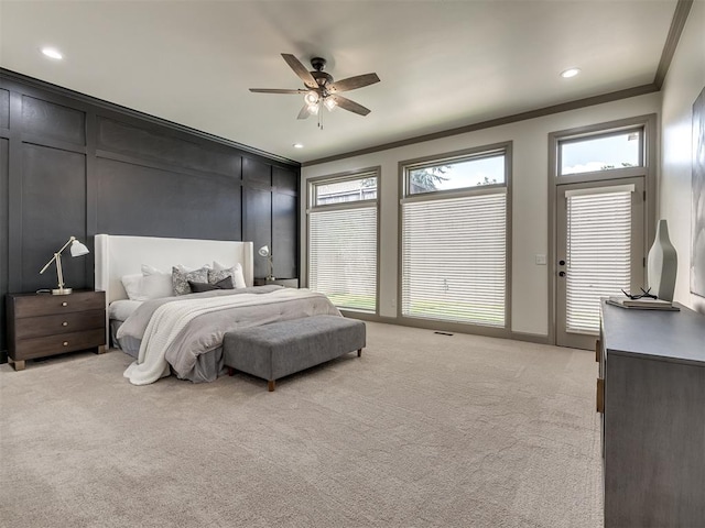 carpeted bedroom featuring ceiling fan and ornamental molding