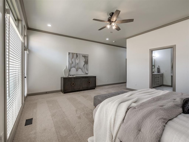 carpeted bedroom with ceiling fan, ornamental molding, and ensuite bathroom