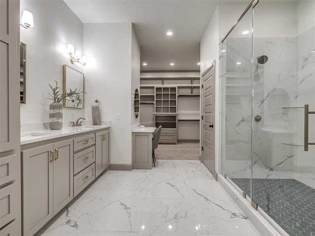 bathroom with vanity and a shower with door