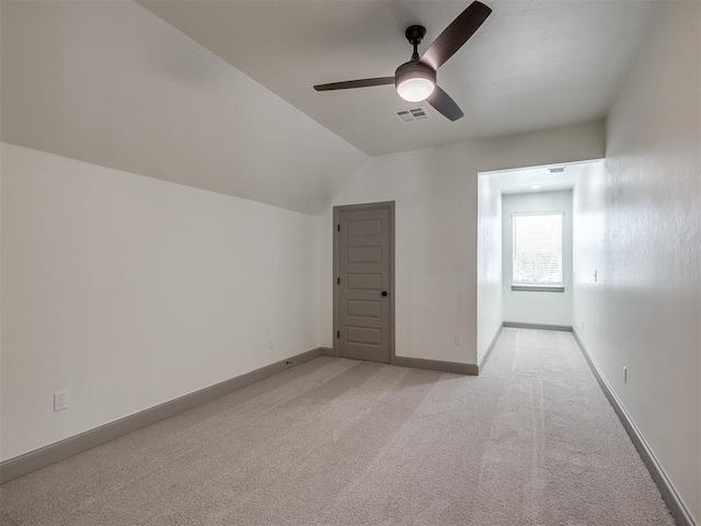 additional living space featuring light colored carpet, ceiling fan, and lofted ceiling