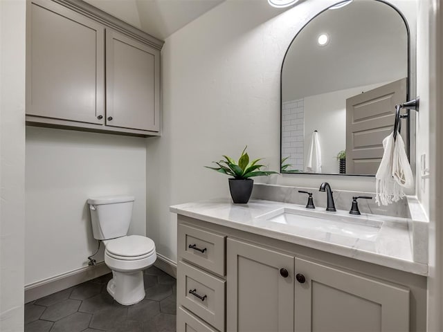 bathroom with tile patterned flooring, vanity, and toilet