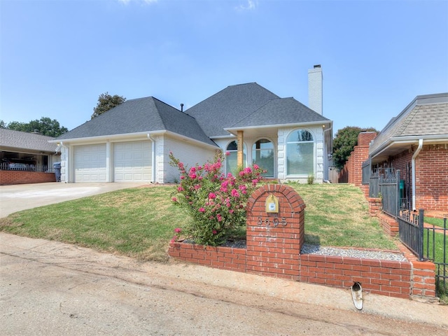 view of front of property with a front yard and a garage