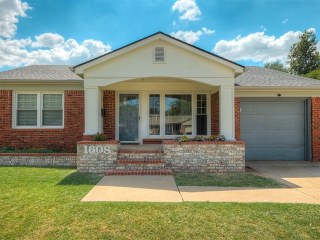 view of front of house featuring a front lawn, a porch, and a garage