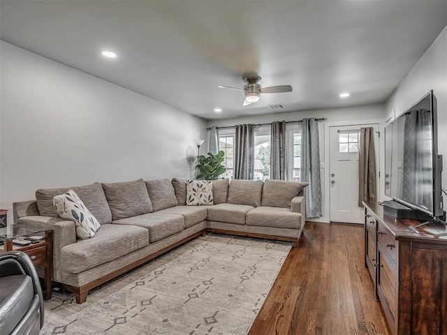 living room with ceiling fan and hardwood / wood-style flooring