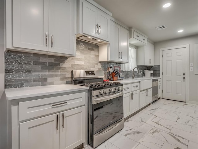 kitchen with decorative backsplash, stainless steel appliances, white cabinetry, and sink