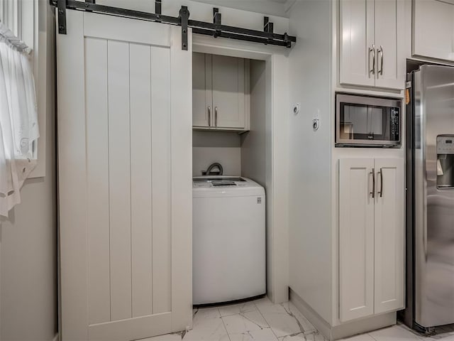 laundry area featuring a barn door and washer / dryer