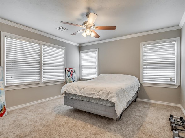 carpeted bedroom featuring ceiling fan and ornamental molding