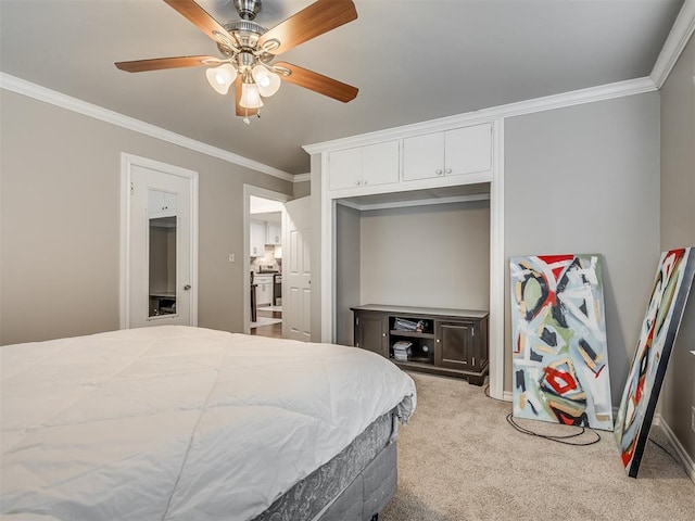 carpeted bedroom with ceiling fan, ornamental molding, and a closet