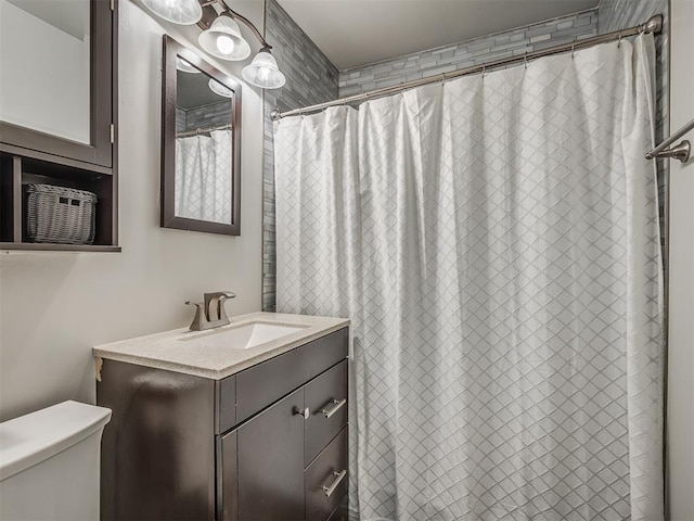 bathroom featuring vanity and toilet