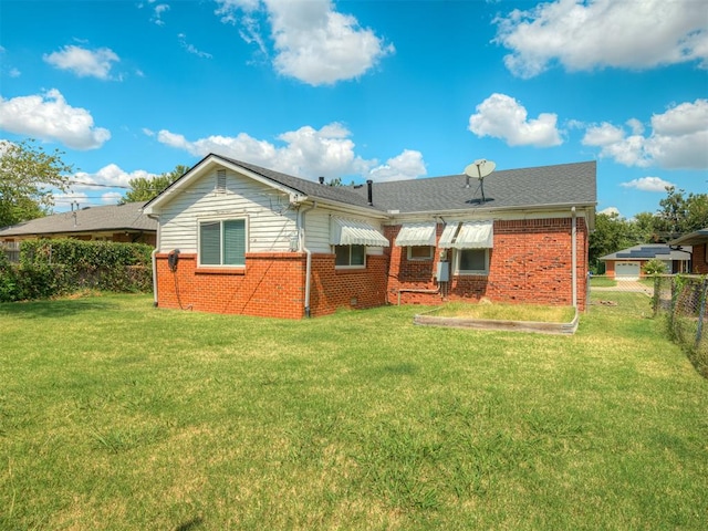 back of property featuring a lawn