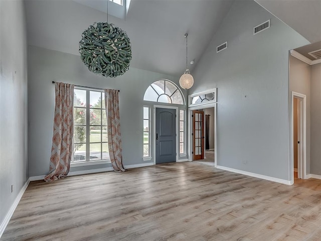 entrance foyer featuring light wood-type flooring and high vaulted ceiling