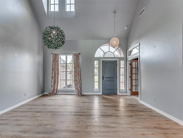 foyer entrance featuring light hardwood / wood-style flooring and high vaulted ceiling