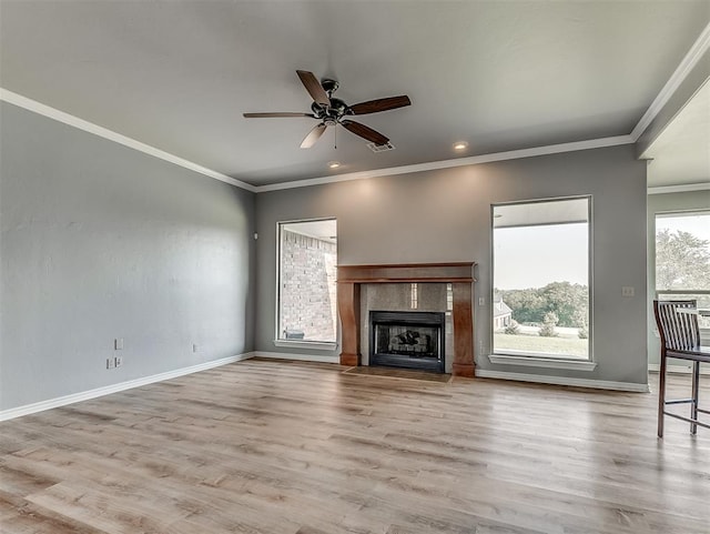 unfurnished living room with ceiling fan, light wood-type flooring, and ornamental molding