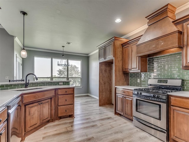 kitchen with pendant lighting, ornamental molding, light hardwood / wood-style floors, custom range hood, and stainless steel appliances