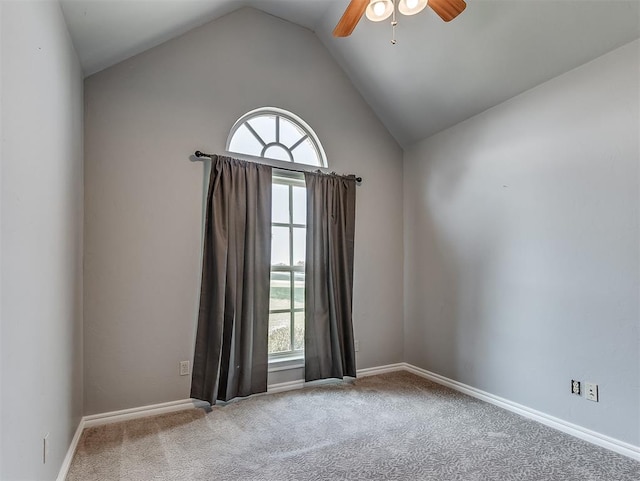 carpeted spare room with ceiling fan and high vaulted ceiling