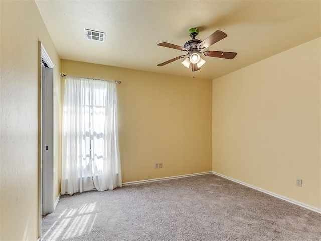 spare room featuring light colored carpet and ceiling fan