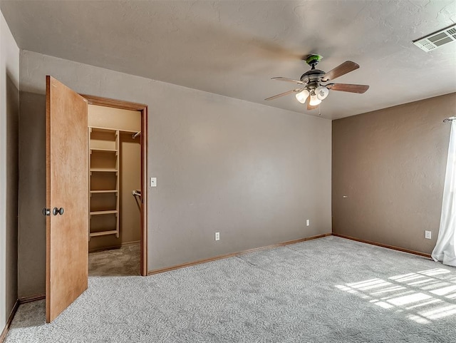 unfurnished room featuring ceiling fan and light colored carpet