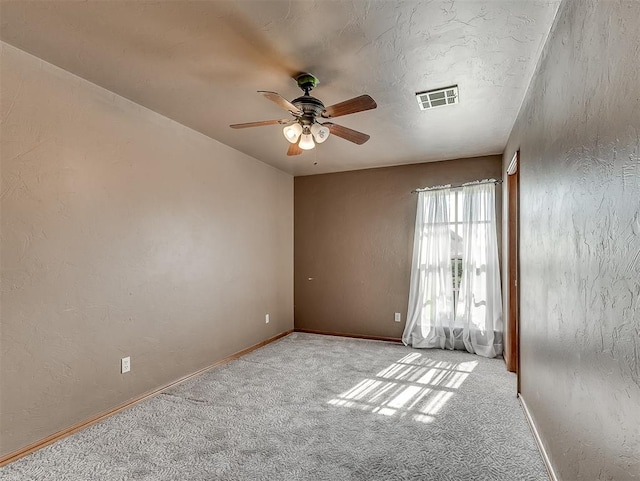 spare room with light carpet and ceiling fan