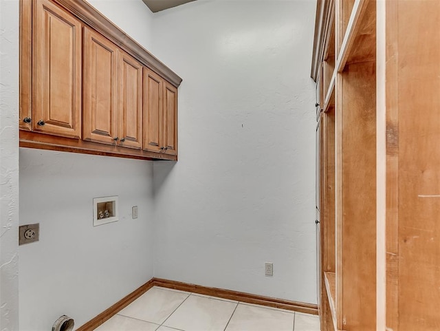 washroom featuring washer hookup, light tile patterned floors, cabinets, and hookup for an electric dryer