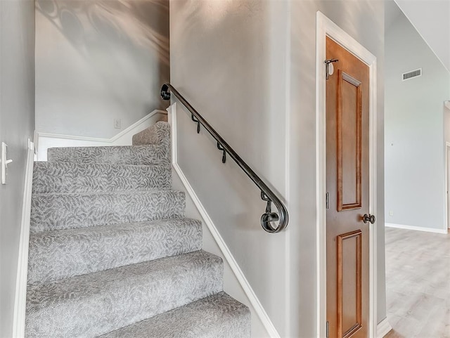 stairway featuring vaulted ceiling