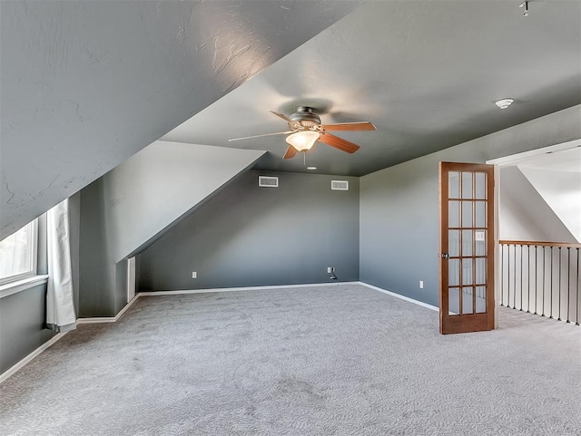 bonus room with ceiling fan, carpet, and lofted ceiling