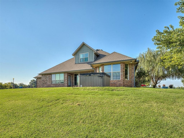 view of front of property with a front yard and a hot tub