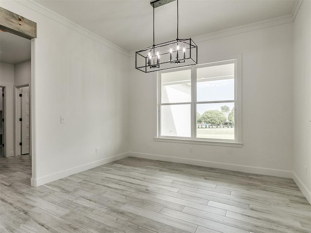 unfurnished dining area featuring a notable chandelier, crown molding, and light hardwood / wood-style flooring