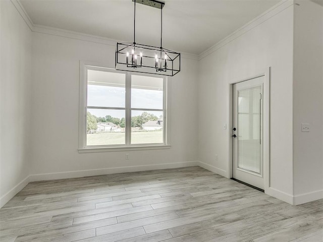 unfurnished dining area featuring ornamental molding, a chandelier, and light hardwood / wood-style floors