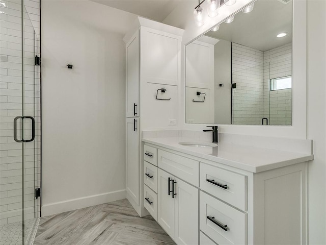 bathroom featuring vanity and a shower with door