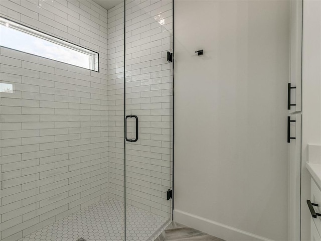 bathroom featuring vanity and an enclosed shower