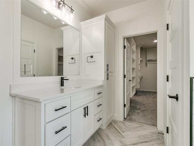 bathroom featuring vanity and parquet flooring