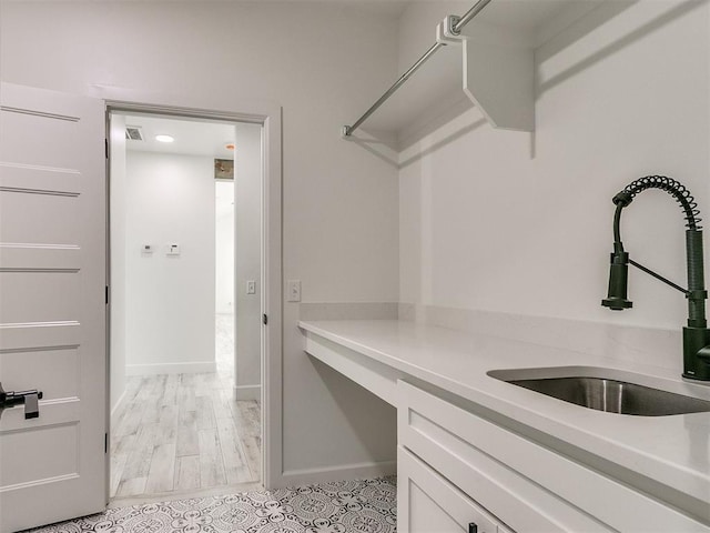 spacious closet featuring sink