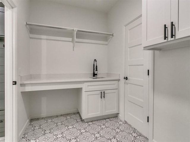 laundry room with sink and light tile patterned floors