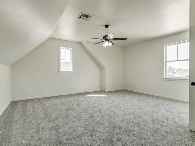 additional living space with ceiling fan, lofted ceiling, and carpet