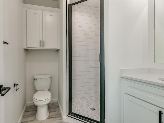 bathroom featuring hardwood / wood-style flooring, vanity, toilet, and walk in shower