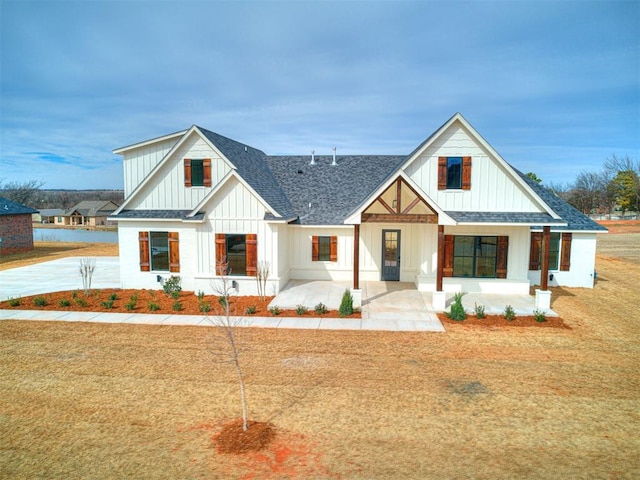 modern farmhouse with covered porch and a front yard