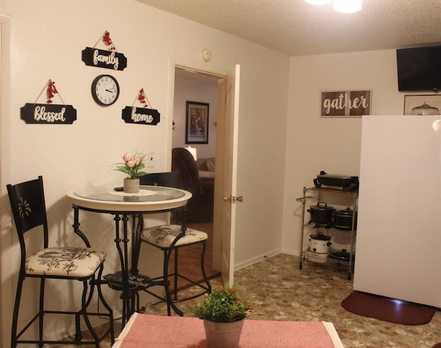 dining area with a textured ceiling