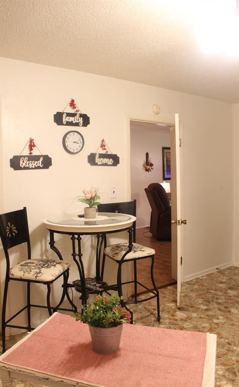 dining area featuring a textured ceiling