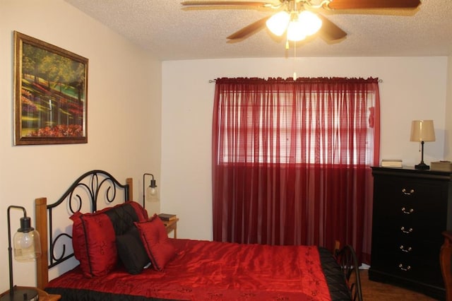 bedroom with ceiling fan and a textured ceiling