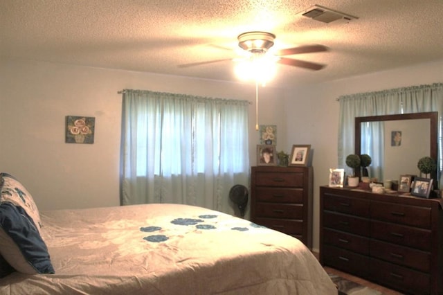 bedroom featuring a textured ceiling and ceiling fan